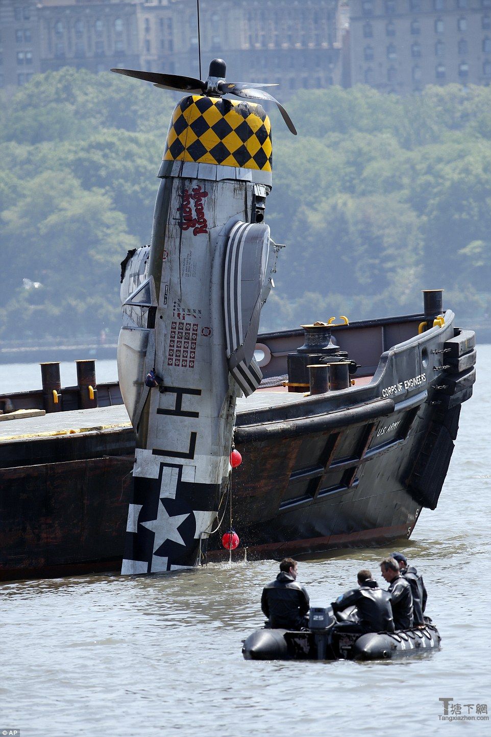 Police divers and Army Corps Of Engineers personnel fished out the P-47 from the Hudson River on Saturday morning (pictured), the day after it crashed into a water, killing its 56-year-old pilot